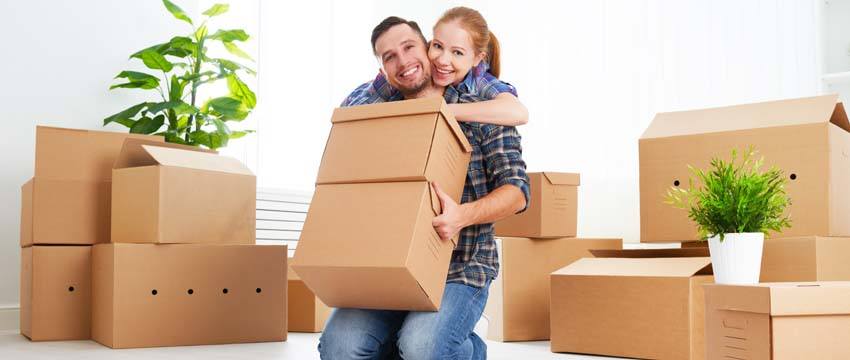 Couple moving cardboard boxes