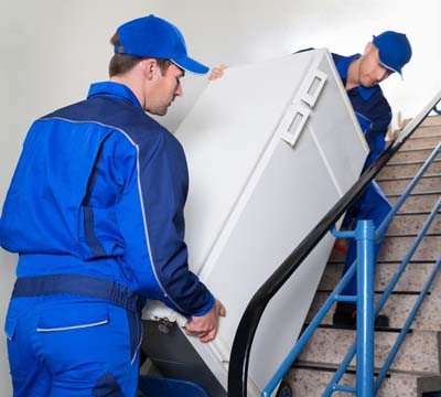 Two men moving fridge